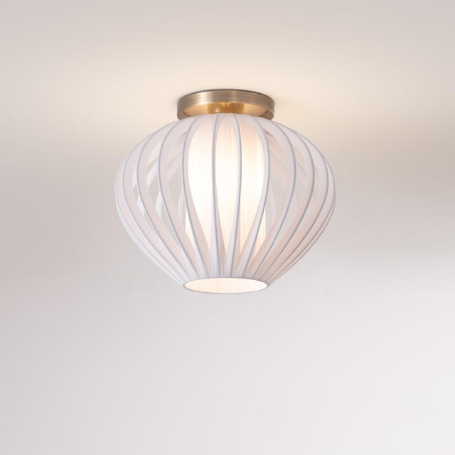 Crafted with a weathered brass steel body and a sphere white satin steel shade, the Bloom Flush Mount is a modern ceiling...