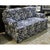 This loveseat features a bold botanical pattern with scrolling leaves and florals set against a deep blue background. Its...