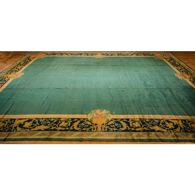 This early 20th-century Irish Donegal Arts & Crafts rug,, characterized by its hand-knotted construction, showcases a...