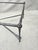 This is a contemporary hammered iron table in the style of Giacometti. Probably from the late 20th century. When cleaning...