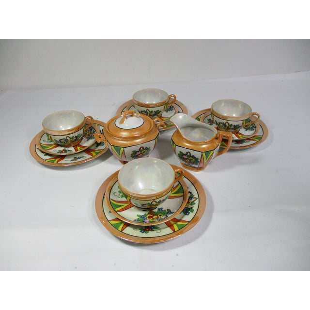 A 1940's Japanese porcelain lusterware luncheon 14 pc set. Consisting of 4 cups, 4 saucers, 4 luncheon plates, sugar bowl...