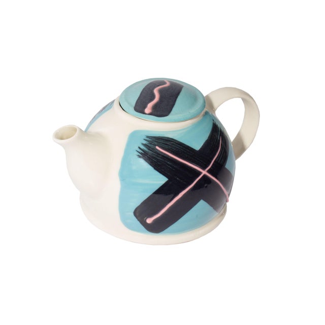 A Postmodern ceramic teapot by Feltman Langer. This teapot has a hand-painted design consisting of a bright blue...