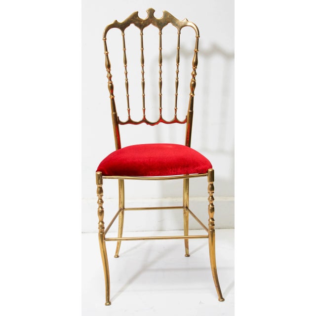 Stunning Italian polished brass Chiavari chair with bat motif and red velvet upholstery, circa 1960s. Designed by Giuseppe...