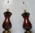 This is a beautiful pair of burgundy brass and ceramic baluster form table lamps, maker unknown. They epitomize statement...