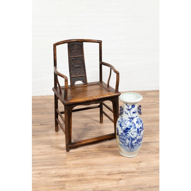 A Chinese Ming Dynasty style elmwood wedding chair from the early 20th century, with carved panels on the splat, curved...