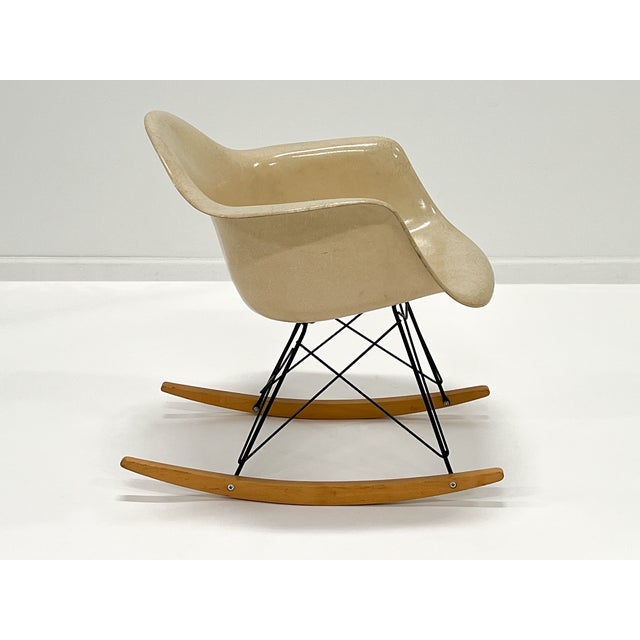 Authentic vintage Herman Miller Eames RAR rocking arm shell chair in parchment molded fiberglass. Designed by Charles and...