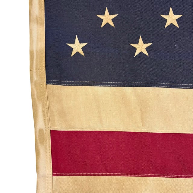 This vintage American flag is made from a cotton cloth, with fully sewn stripes and embroidered stars. Please note overall...