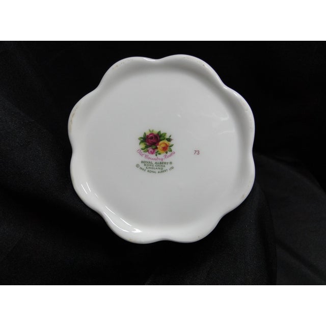 Add a touch of timeless English elegance to your home with this **vintage Royal Albert Old Country Roses Montrose Vase**....