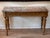 An elegant and solidly built carved giltwood French console with a variegated rouge marble top. The deep apron is carved...