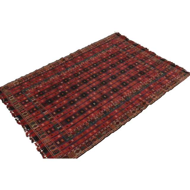 Handwoven in wool from Russia originating between 1880-1890, a 6x9 antique Verneh kilim enjoying a union of tasteful...
