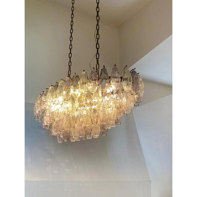Italian oval hand- made chandelier in brunito- burnished finishing. champagne, pink and ametista color of “poliedri”...