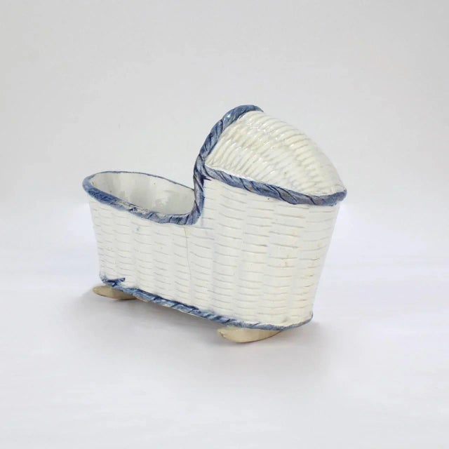 A rare, large English pearlware or Staffordshire pottery cradle. Decorated with an overall basketweave pattern and blue...