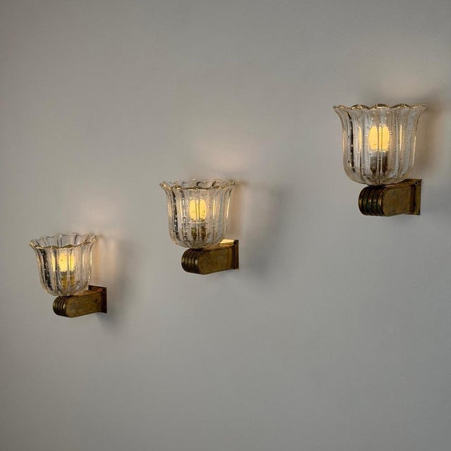 A striking set of three Art Deco wall sconces designed by Ercole Barovier for Barovier & Toso, Italy, circa 1940s. These...