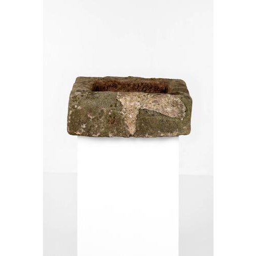 A primitive shallow sandstone trough of rough hewn square form. Sourced from a Cotswold estate. English, circa 1800.