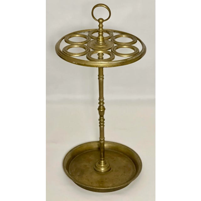 19th century solid brass umbrella stand. Beautiful six section holder featuring a ring shaped handle, finely turned...