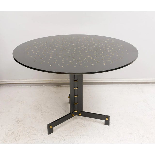 Ebonized circular table on steel and brass base with hand-incised gold-leafed lacquered top. Table can be crafted to your...