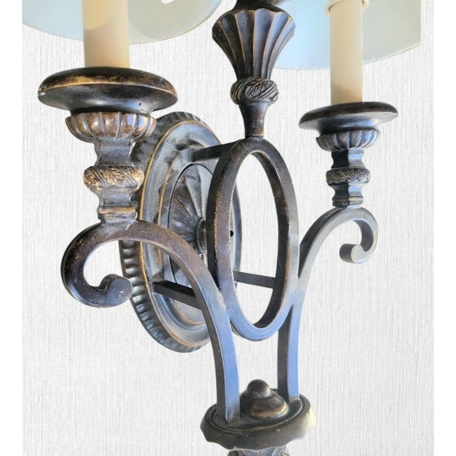 A beautiful iron French style 2 arm wall sconce lamp. The lamp features pretty curved details with a raised design and a...