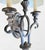 A beautiful iron French style 2 arm wall sconce lamp. The lamp features pretty curved details with a raised design and a...