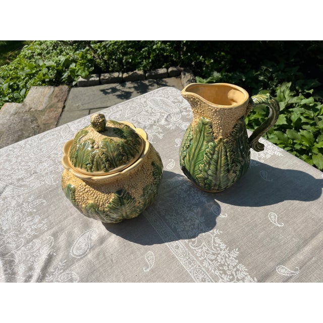 Vintage Majolica Lidded Cauliflower jar and pitcher. Jar measures about 10 1/2" tall x 8 1/2" wide. Pitcher measures about...