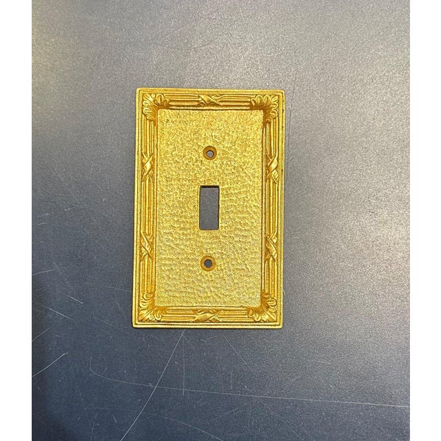 Set of 12 Sherle Wagner Ribbon and Reed Single Switch Plates. Burnished Gold Finish.