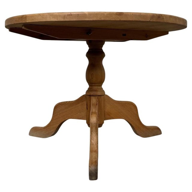 A handsome and highly practical 19th-century English Victorian breakfast table, beautifully crafted in pine and...