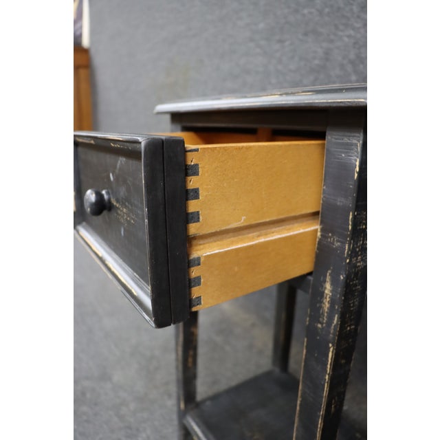 Pair of country style nightstands with a simple, open frame design. Each features a single drawer with a round wood knob,...