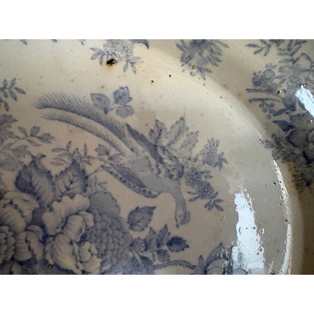 An oval Asiatic Pattern Staffordshire pattern, platter.. The piece has a crisp pattern in a clear cornflower blue. The...