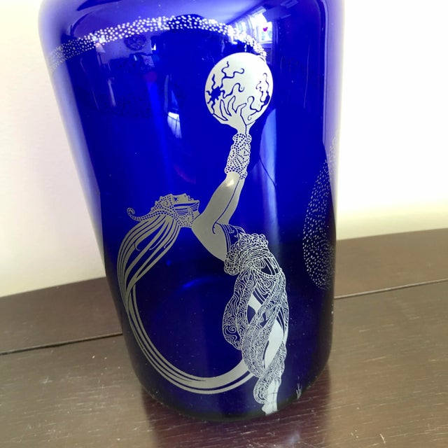 An Erté "Fireflies" blue glass and silver metallic vase by Franklin Mint.