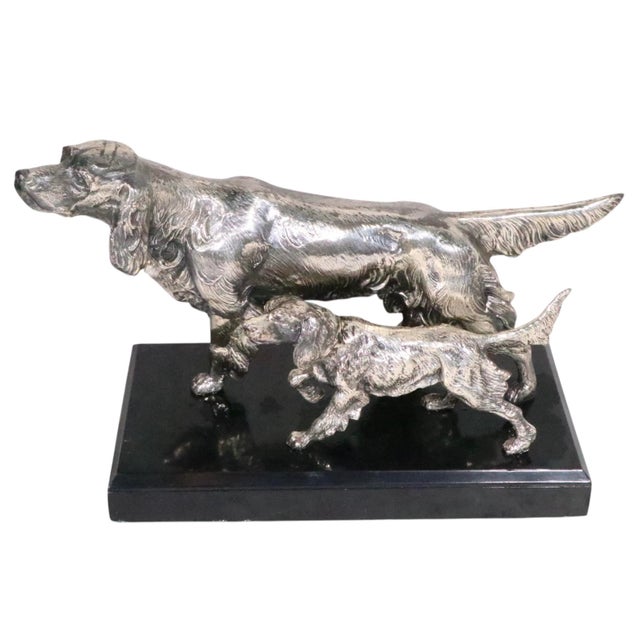 Exceptional pair of silvered metal bookends, each depicting two Setters mounted on a black plinth base. The bookends are...