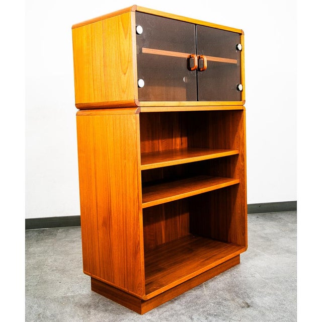 2 piece Danish teak bookshelf cabinet with 2 doors glass display that sits above. Unsigned example.