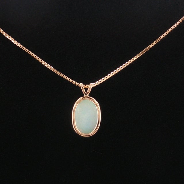 This mid-20th-century pendant features a captivating opal as its centerpiece. The opal, weighing approximately 2.25...