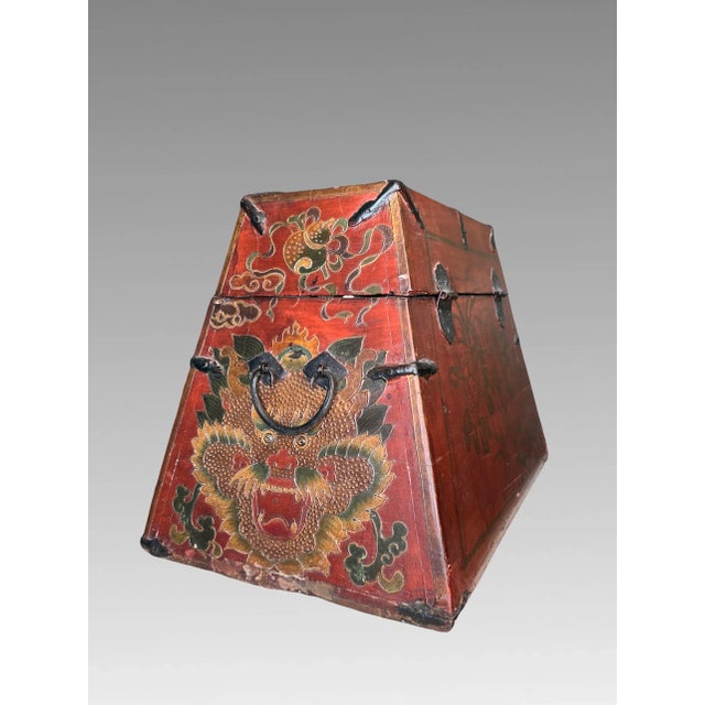 Antique Chinese hand decorated trapezoid shaped "Dragon Box' with original iron fittings. Late Qing Dynasty. The...