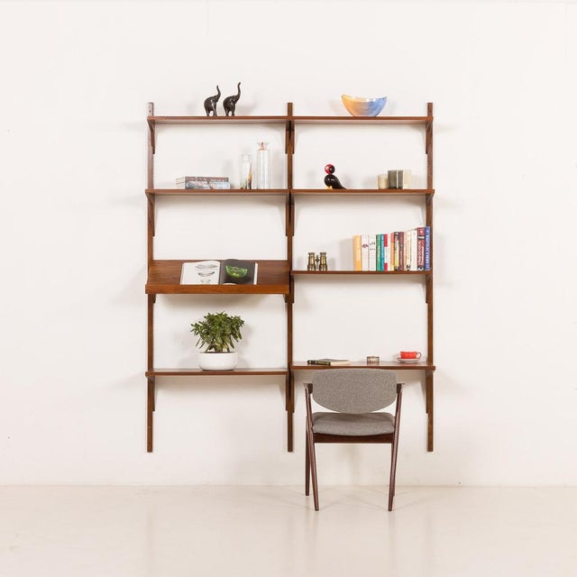 This danish mid-century walnut shelving unit comes from the 1960s and was most likely produced by cadovius, as indicated...