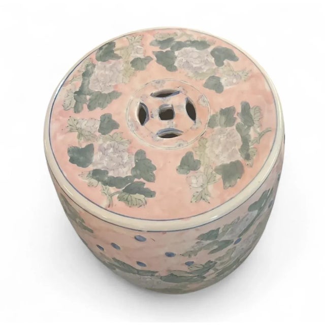 This charming ceramic garden stool, hand-painted in a delightful palette of blush pink, soft green, and subtle blue,...