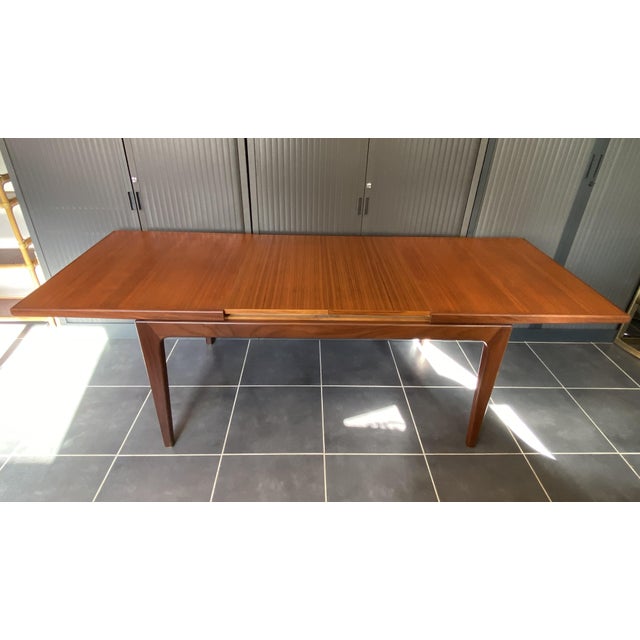 Beautiful extendable dining table in teak and teak veneer. 1960s, some signs of wear, good overall condition. This table...
