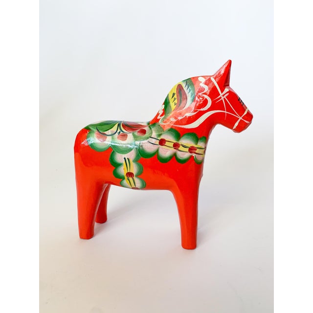 A charming little hand painted Swedish Dala horse by Nils Olsson. The detail and condition is pristine. Maker's mark...
