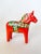 A charming little hand painted Swedish Dala horse by Nils Olsson. The detail and condition is pristine. Maker's mark...