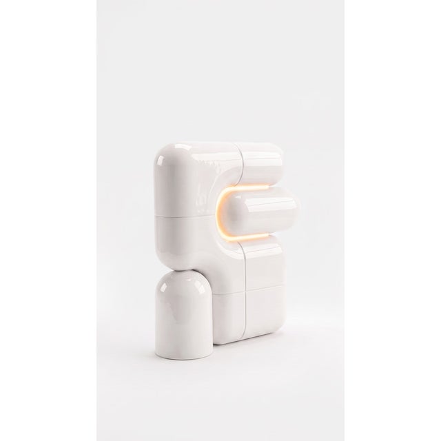 The smallest lamp in the collection, and often the first one people reach for. Its folded form hides the source entirely,...