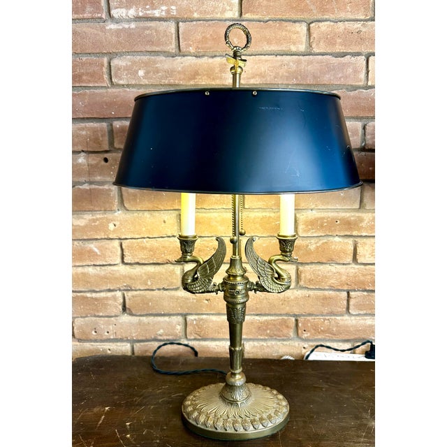 Add a commanding touch of Neoclassical elegance to your space with this exceptional pair of French Empire-style bouillotte...