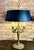 Add a commanding touch of Neoclassical elegance to your space with this exceptional pair of French Empire-style bouillotte...