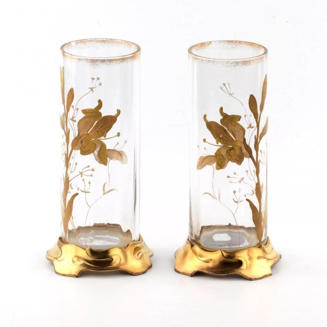 A pair of vases, decorated with gilded, enamel art in the Art Nouveau style.