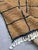 Brown Grid Moroccan Rug – Handmade Berber Wool Carpet This elegant handmade Moroccan rug features a warm brown wool field...