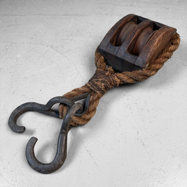This antique Japanese pulley is a striking piece of utilitarian craftsmanship from the Meiji period. Dimensions: height 35...