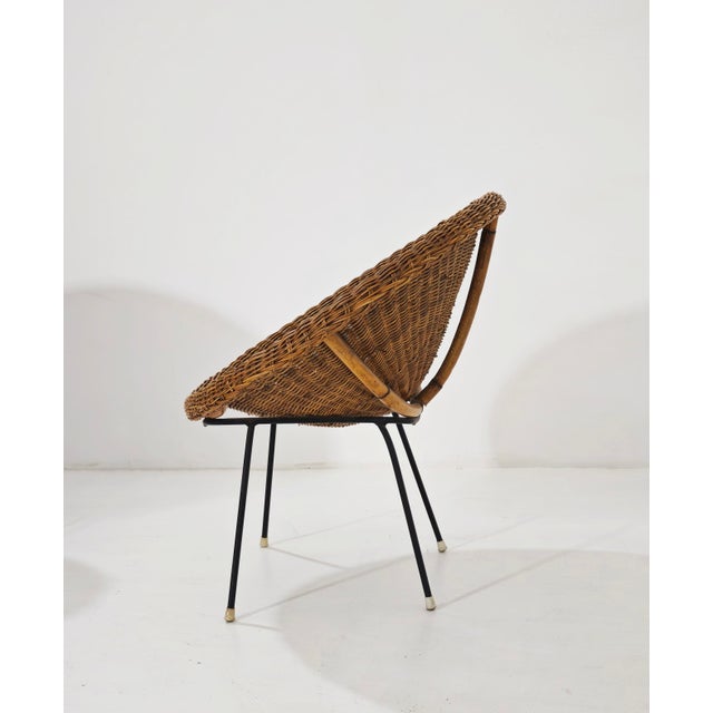 A pair of Mid-Century Modern basket chairs, a classic piece of Italian modern design. The hemispherical or inverted cone-...