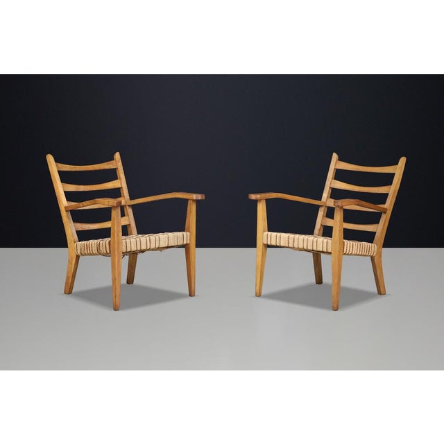 Pair of Sculptural Italian Armchairs in Patinated Beech, 1940s A remarkable pair of Italian armchairs dating from the...