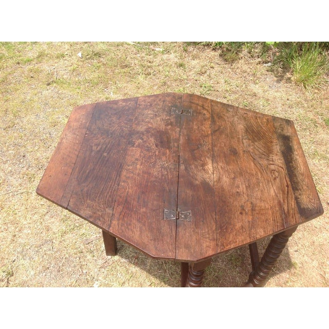 A Charles II Oak Credence Table 1650. Original flip over oak top with original butterfly hinges. Turned bobbin legs. Draw...