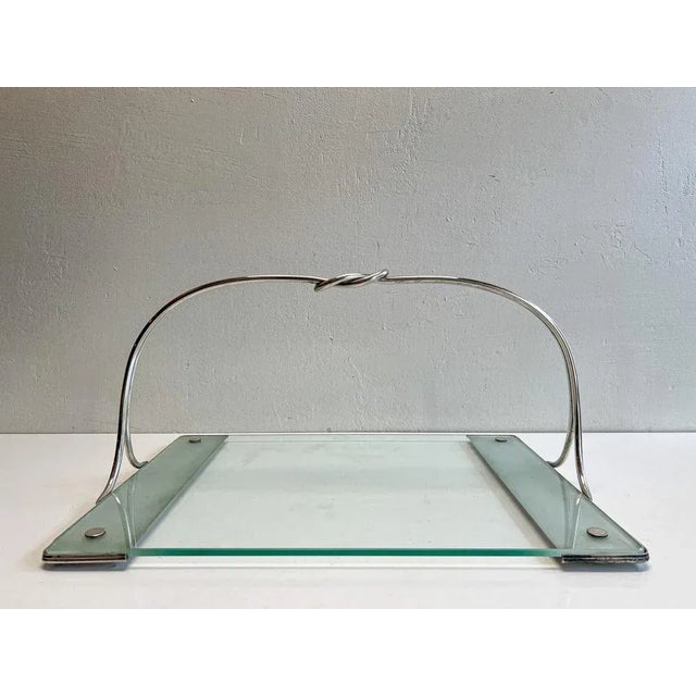 A stylish snack tray made by Arthur Krupp Milano. The mark stamp tells that this object was made between 1938 and 1945....