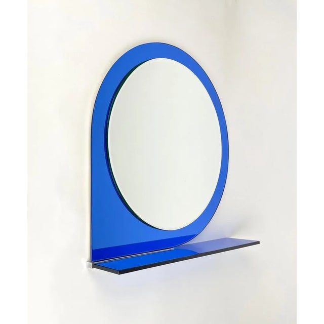 Wall mirror with shelf framed by blue glass by Sena Cristal. Made in Italy in 1974. The original label is still attached...