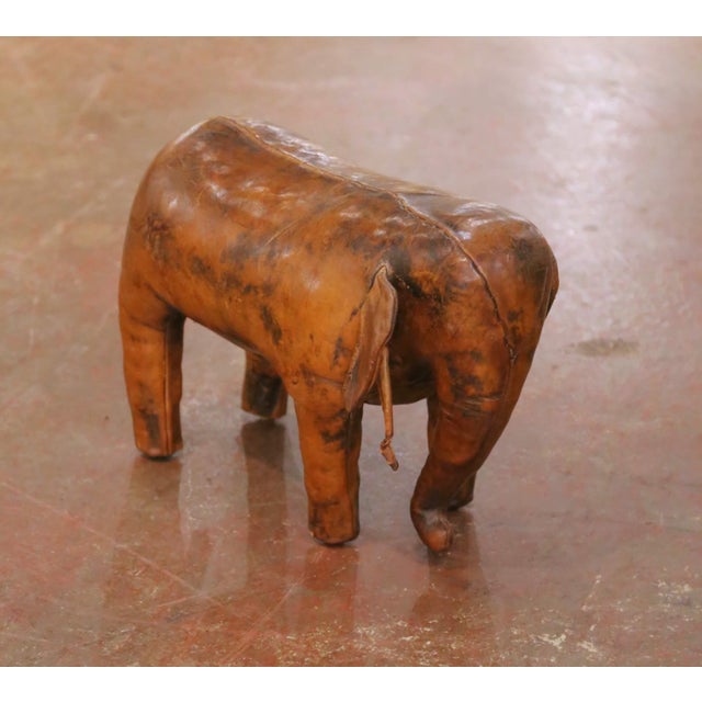 Rest your feet on this charming vintage elephant stool. Crafted in Spain circa 1970, the freestanding sculptural stool is...