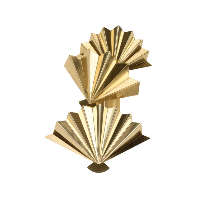 This art deco inspired sconce, finished in polished brass, serves as a unique wall sculpture and has the ability to...